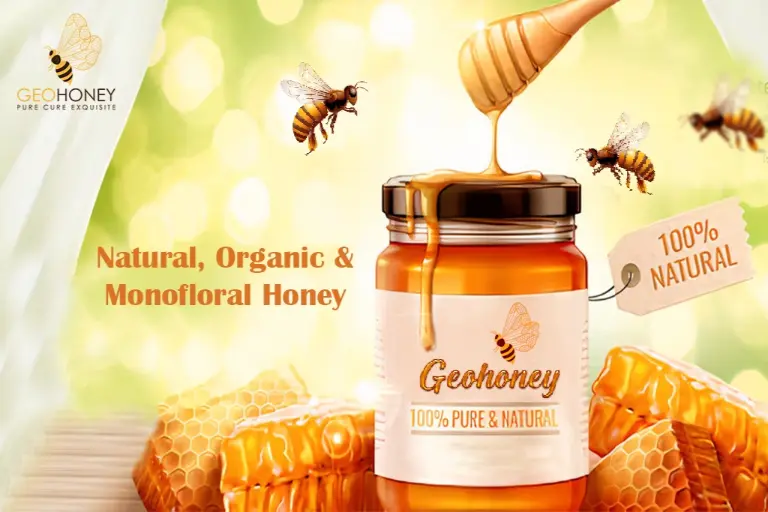 A jar of honey with a wooden spoon on a blurred background with honeycomb cells visible.
